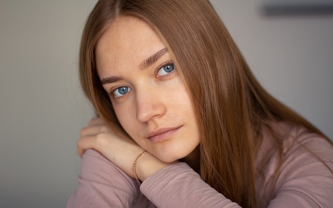 attractive slavic woman with blue eyes starring into camera